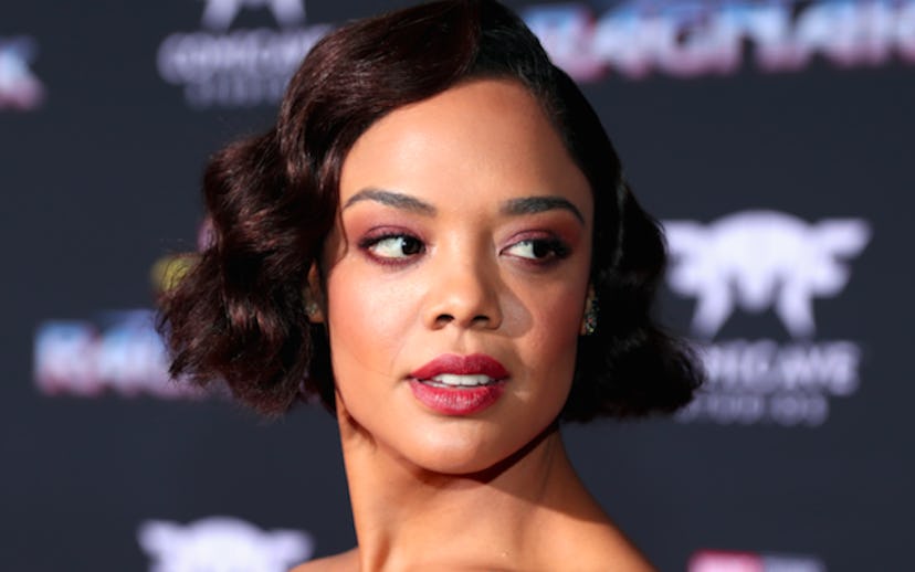 Tessa Thompson with short hair getting her photo taken at an event