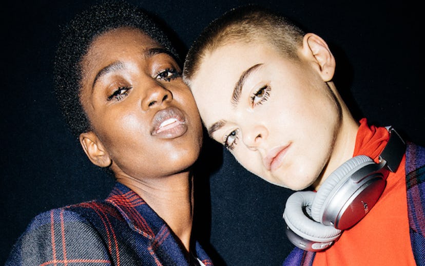 Two young females with short hair and long lashes posing for a selfie
