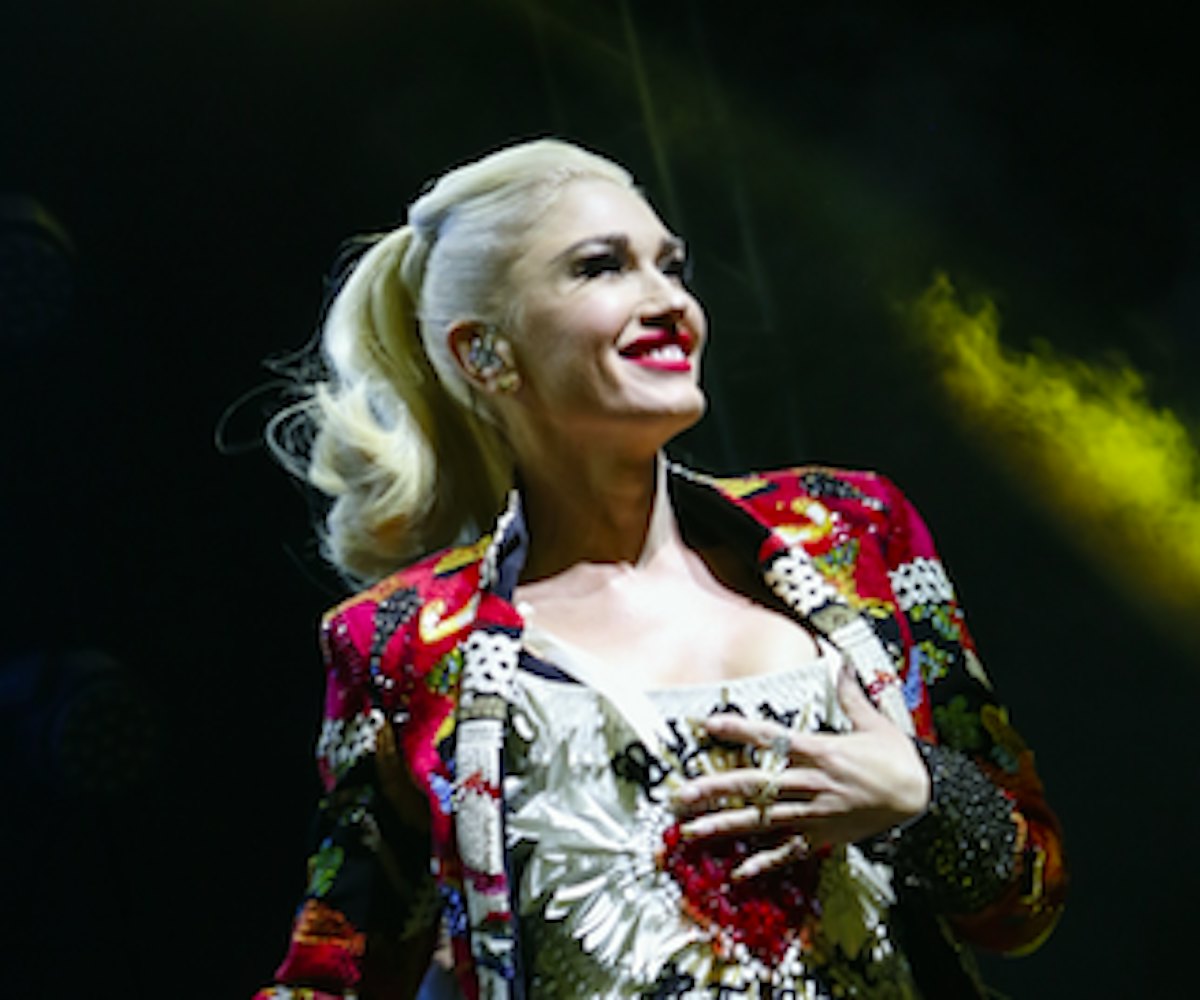 Gwen Stefani on stage in a multicolored blazer