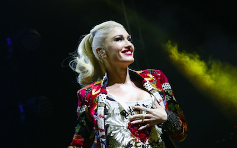 Gwen Stefani on stage in a multicolored blazer