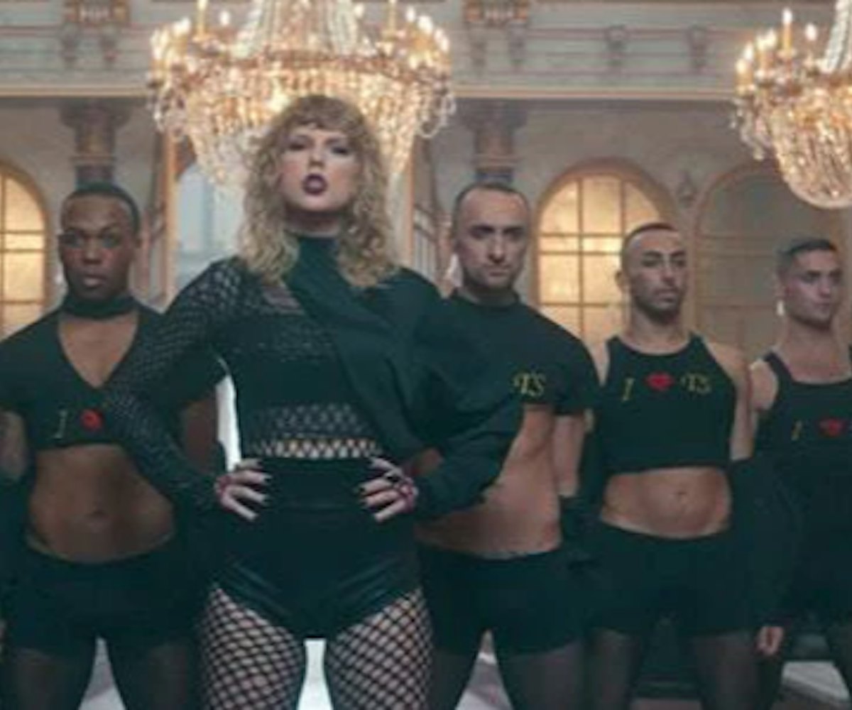 Taylor Swift standing next to seven men while wearing dark clothes for the 'Look what you made me do...