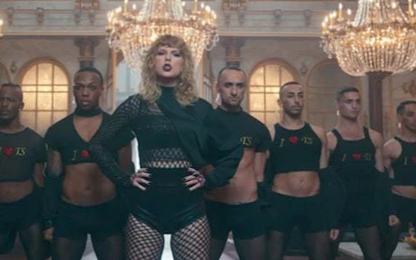 Taylor Swift standing next to seven men while wearing dark clothes for the 'Look what you made me do...