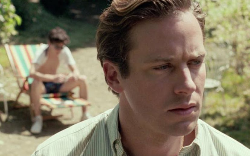 A still from "Call Me by Your Name" with Armie Hammer in focus and Timothée Chalamet in the backgrou...