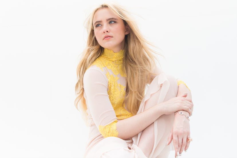 Kathryn Newton wearing a yellow and white long sleeve shirt 