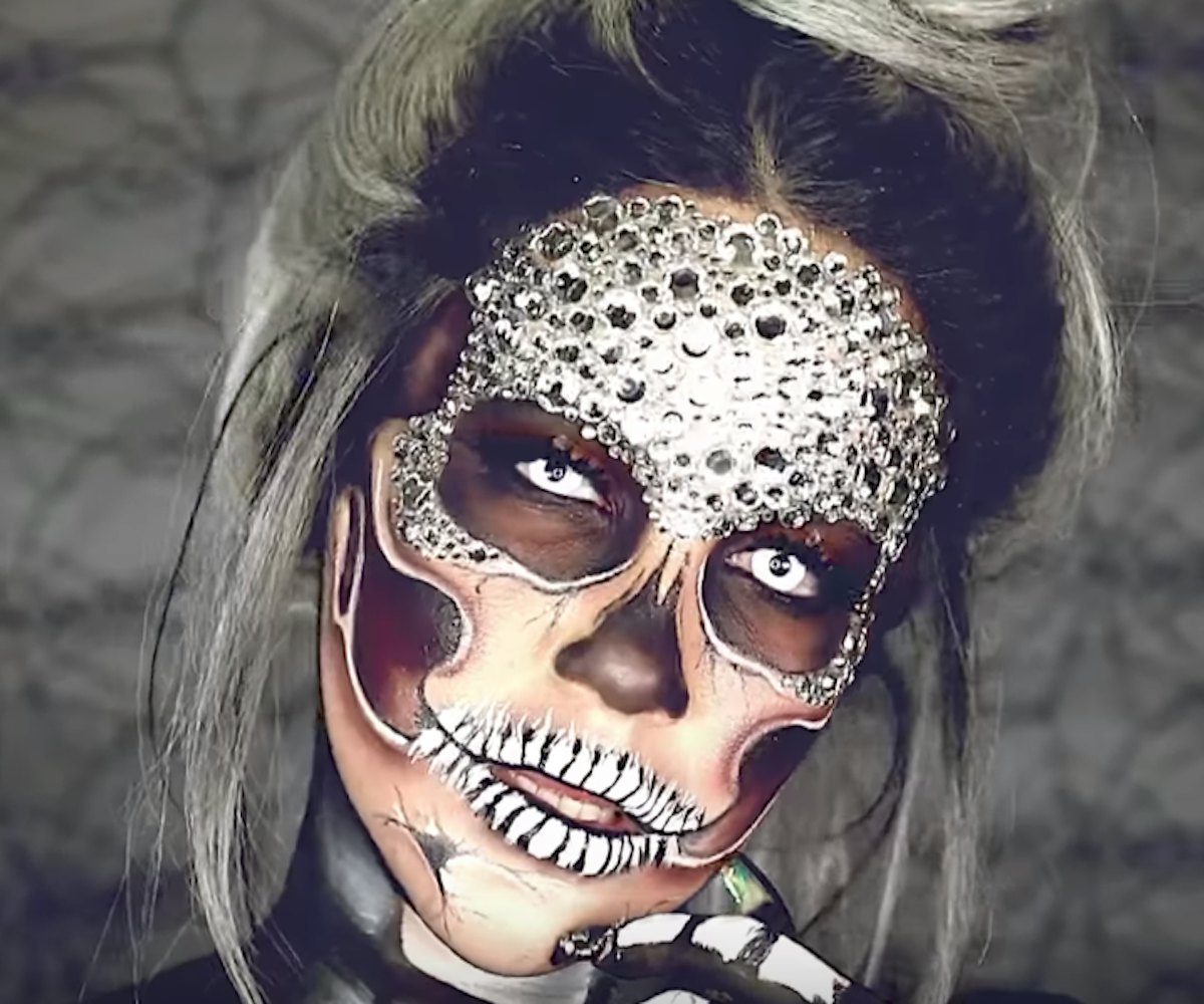 MUA Nicole Guerriero's with a glam-skull face painting with rhinestones in black and white with her ...