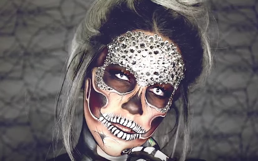 MUA Nicole Guerriero's with a glam-skull face painting with rhinestones in black and white with her ...