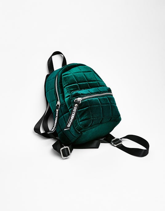Bershka's mini velvet emerald green backpack with black straps and two zippers