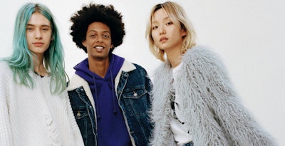 Three models promoting Bershka clothes: one is in a white sweater, one in a grey feather jacket and ...