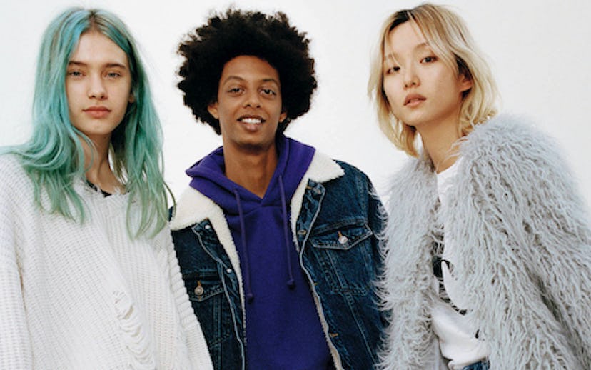 Three models promoting Bershka clothes. One is in a white sweater, one in a grey feather jacket, and...