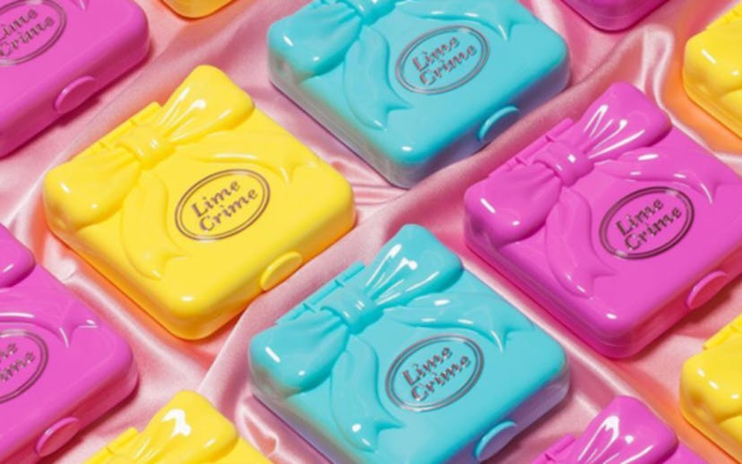 Lime Crime's Polly Pocket-inspired makeup palettes in light blue, yellow, and pink packaging