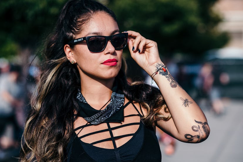 A girl in a black top and a black bandana around her neck