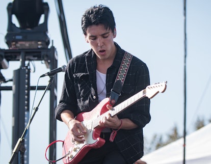 Christo Bowman from Bad Suns playing an electric guitar on stage 