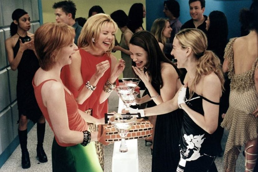 Sarah Jessica Parker, Kim Catrall, Cynthia Nixon and Kristin Davis laughing at a party in a scene fr...