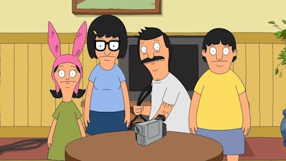 Louise, Bob, Tina and Gene Belcher standing around a table with a camera on it, looking confused in ...