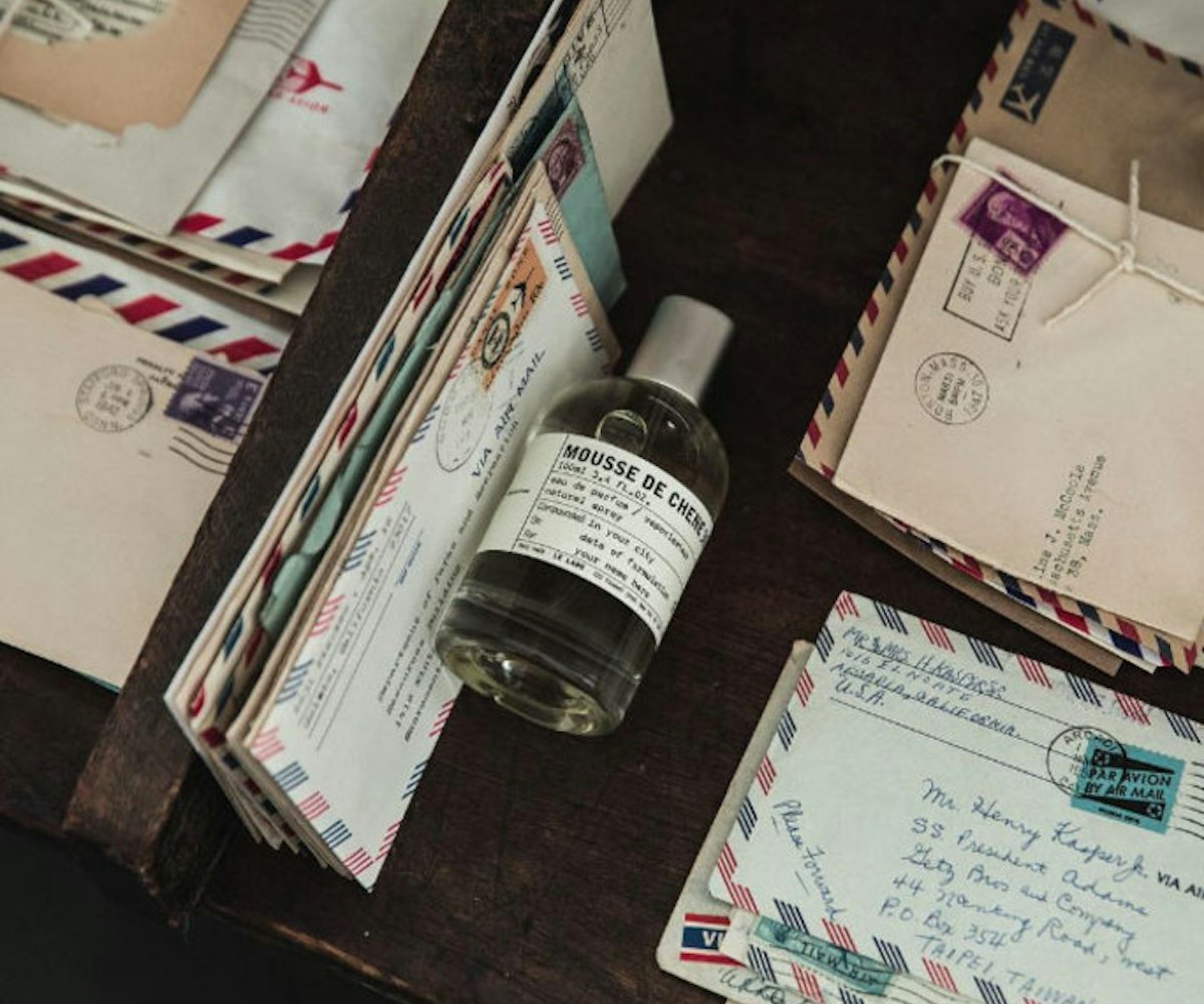 A bottle of Mousse de Chen perfume between letters from Le Labo’s City Exclusives 