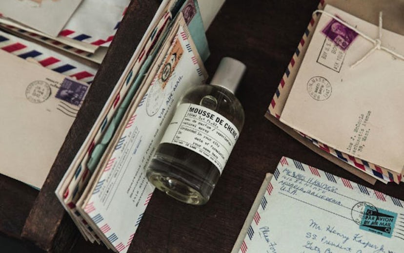 A bottle of Mousse de Chen perfume between letters from Le Labo’s City Exclusives