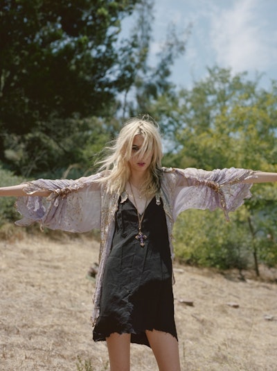 Lead singer of the band Starcrawler, Arrow de Wilde wearing a black dress and a cross on her neck st...