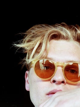 Chris Taylor from the rock band "Grizzly Bear" with yellow sunglasses on