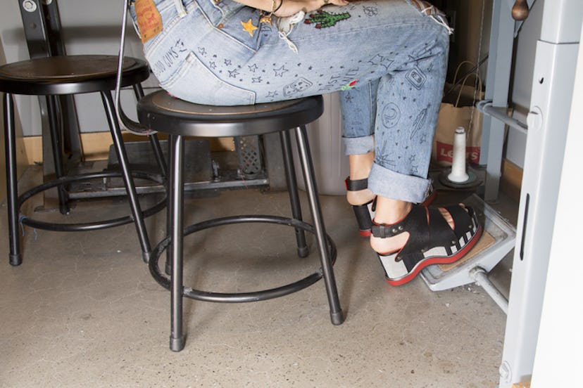 Levi's jeans with little black stars and figures drawn on the back representing space