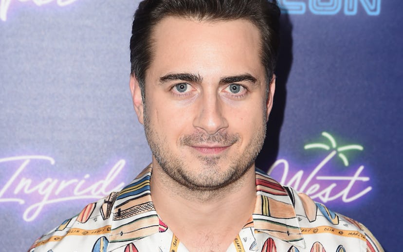 Matt Spicer posing in a beach shirt with surf boards drawn on it