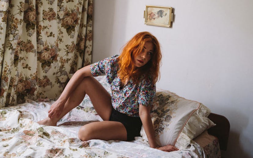 Singer, songwriter, and producer Jess Cornelius in a floral short-sleeved shirt and black shorts whi...
