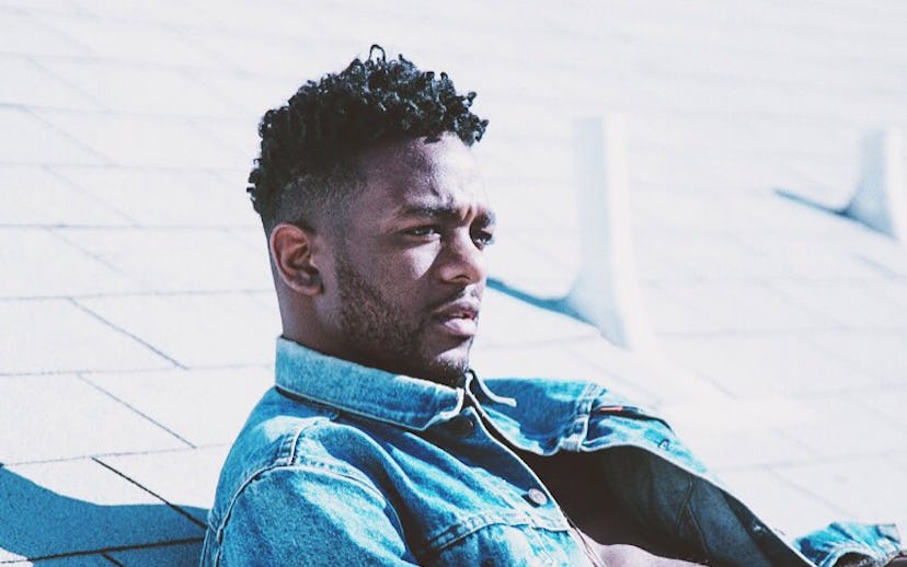 Jaylien Wesley lying on the ground in a denim jacket