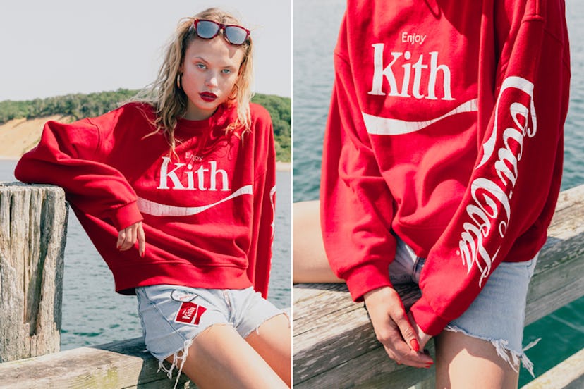 Blonde female model posing on a beach in Kith x Coca-Cola hoodie and shorts
