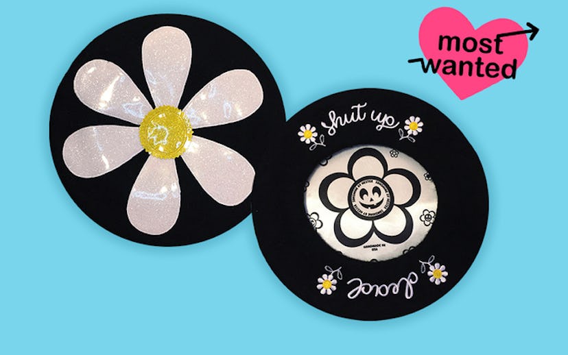 Two black and white Hester berets with dandelion embroidery and the 'words shut up' and 'dead'
