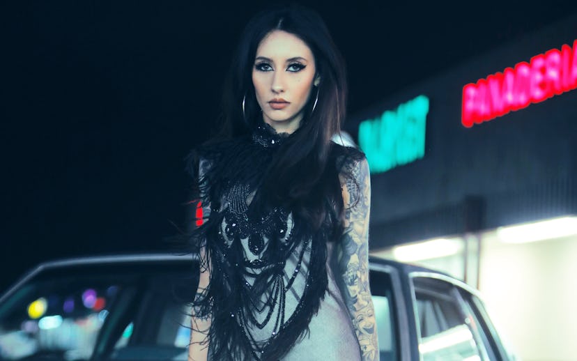 Natasha Lillipore in a black and gray dress leaned against her ’79 Chevrolet Monte Carlo.