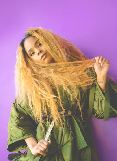 Tayla Parx posing in front of a purple background