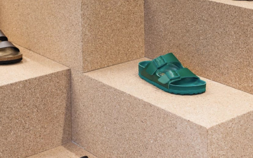 Black, brown, and green Birkenstock slippers