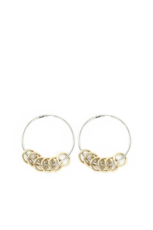 Silver Gloria earrings model with six golden rings on each earring by Justine Clenquet