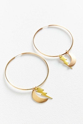 Golden Charm hoop earrings model with thunder and moon tags by Urban Outfitters