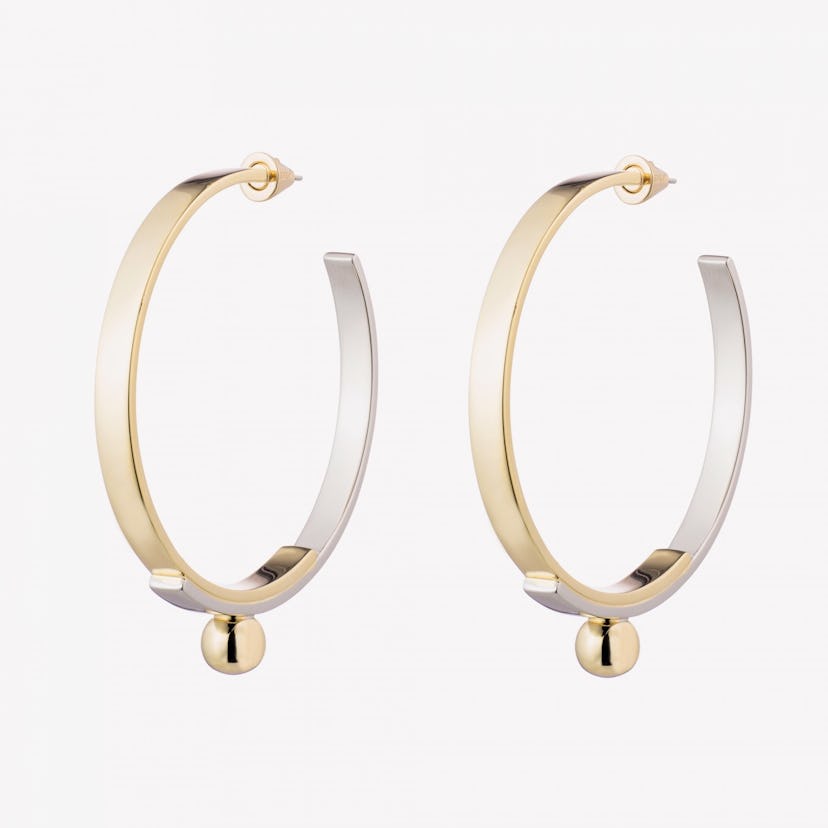 Half-golden and half-silver layered plate hoop earrings by Eddie Borgo