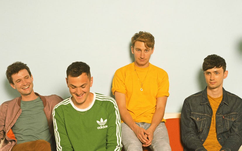 Drew Mac Farlane, Joe Seaweed, Dave Bayley, and Edmund Irwin sitting on an orange couch