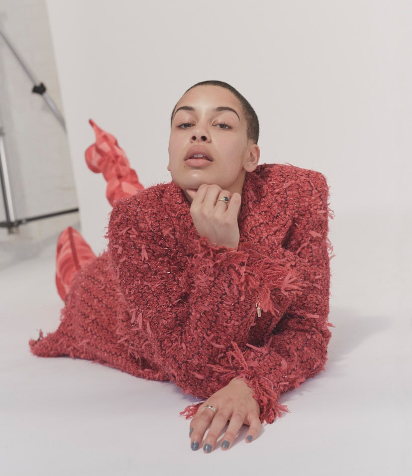 Jorja Smith in a red fringe dress red high-heeled boots