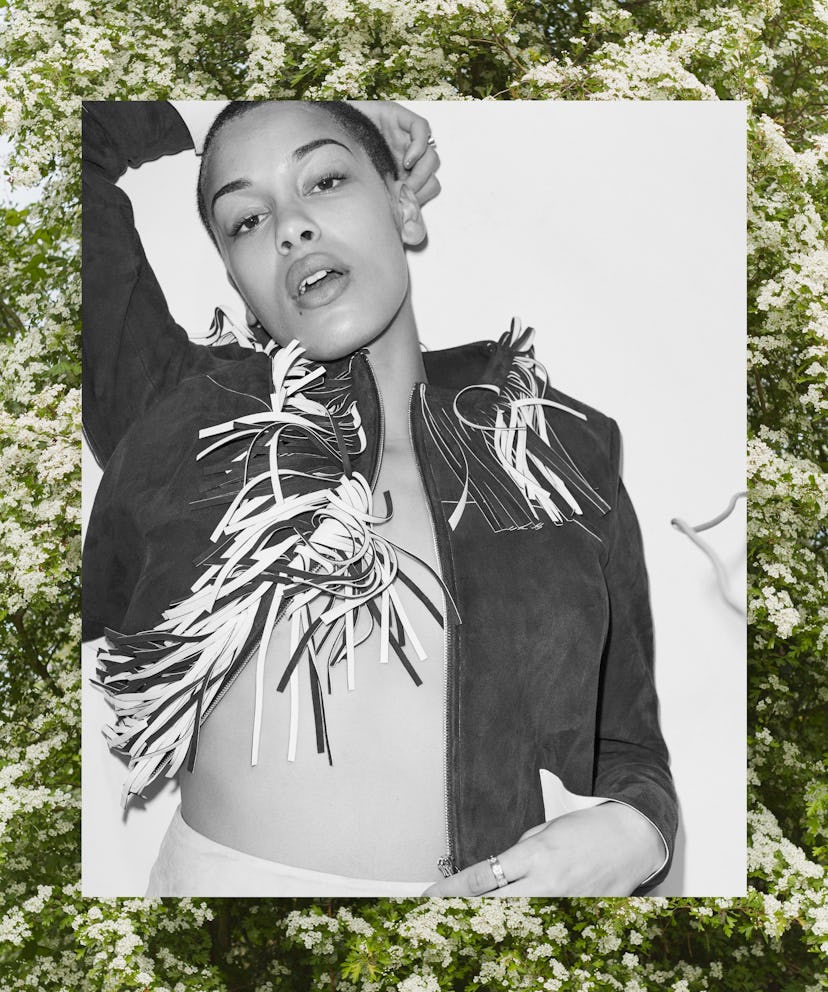 Black and white photo of Jorja Smith in a short suede fringe jacket