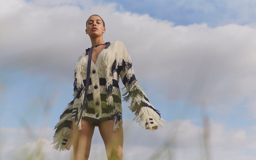 Singer Jorja Smith in a black and white striped sweater with fringe sleeves and a fringe on the fron...