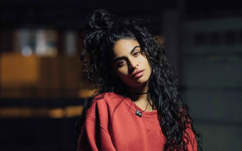 Canadian singer and songwriter Jessie Reyez in a red sweatshirt