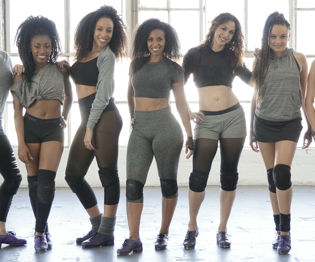 Group picture of the Syncopated ladies, Chloe, Maud, and others wearing gray shirts and leggings for...