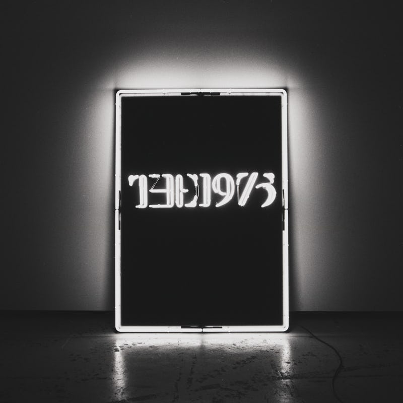 A neon sign in black and white letters that says "the 1975" 