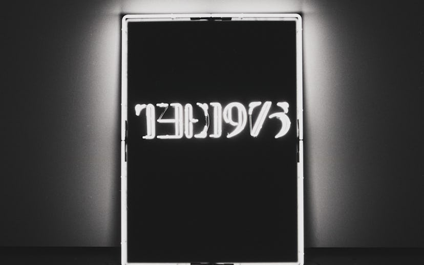 A neon sign in black and white letters that says "the 1975"