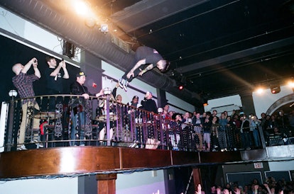 A man jumping and doing a flip into the crowd on the Wavves show