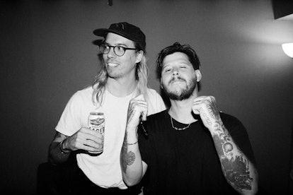 Nathan Williams of the Wavves standing next to a long haired man with glasses and a cap