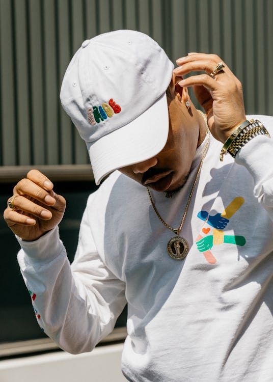 Taylor Bennett wearing a white cap with "Pride" on it