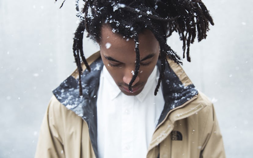 Conner Youngblood with a dreadlock hairstyle with snowflakes in his hair