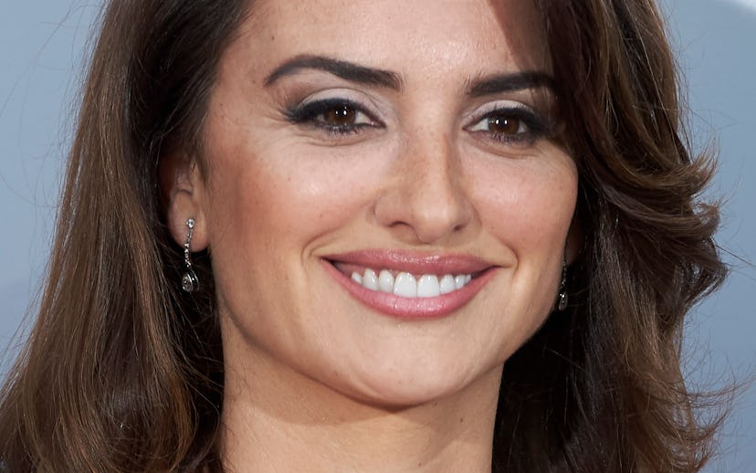 Penelope Cruz wearing a white dress with thin shoulder and neck straps