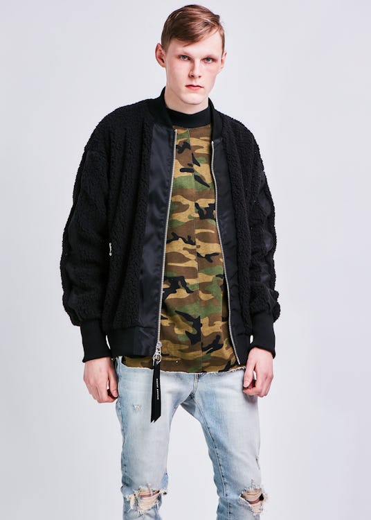 A male model wearing the hero bomber sherpa two in black