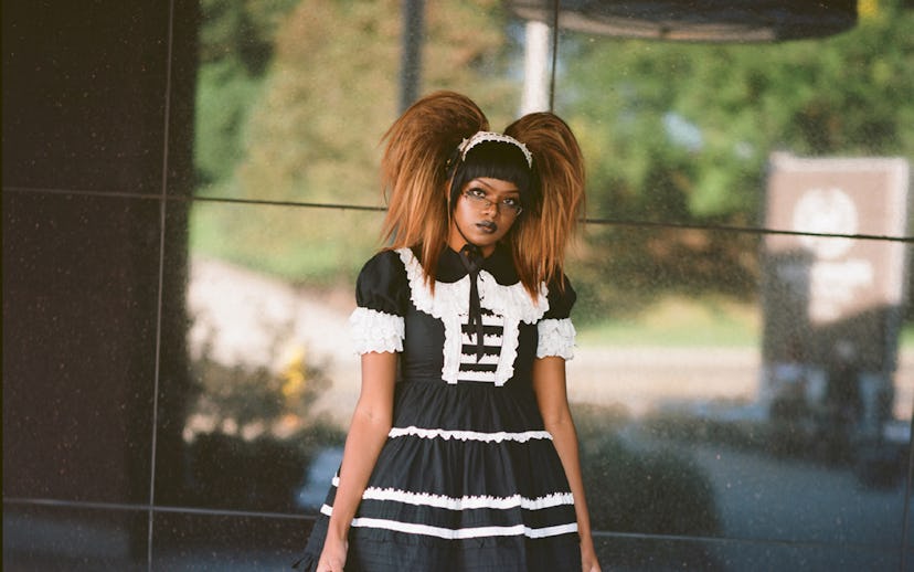 Girl with high pigtails wearing a bell-shaped skirt, knee-high socks, and high platform shoes