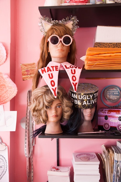 A shelf in Stella Rose Saint Clair's house that has wig heads and many personal details